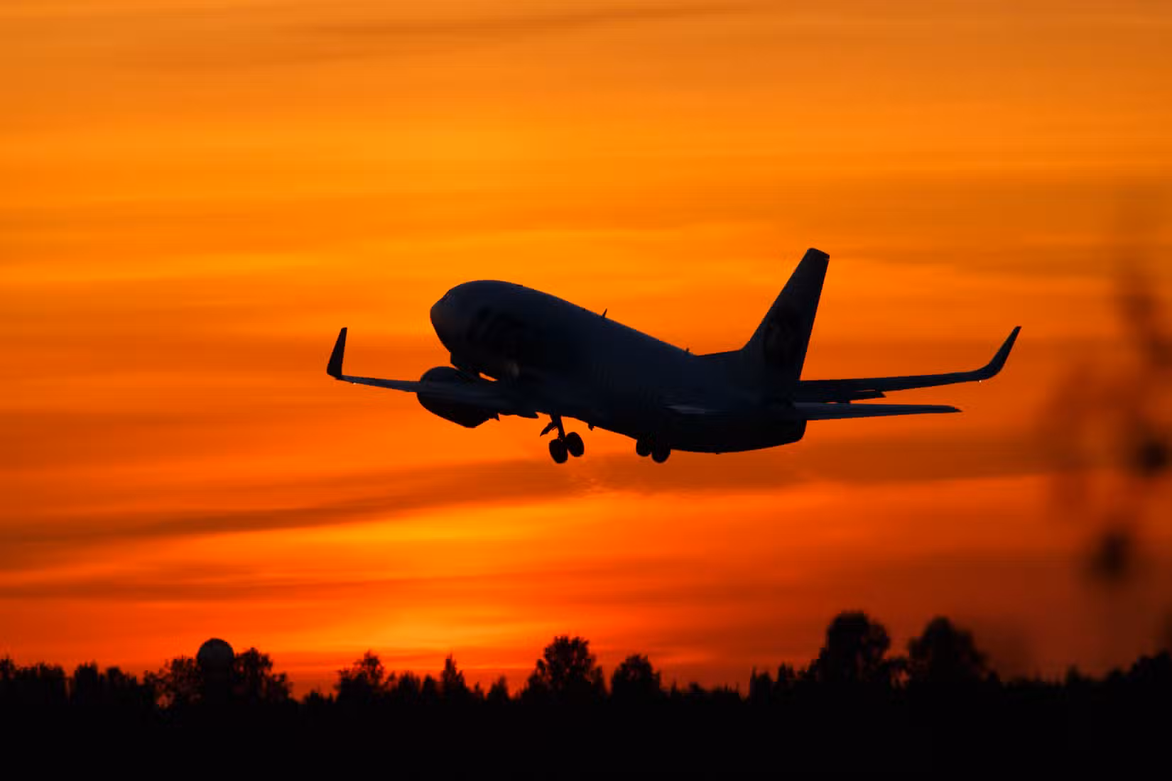 Boeing 737 taking off into the sunset