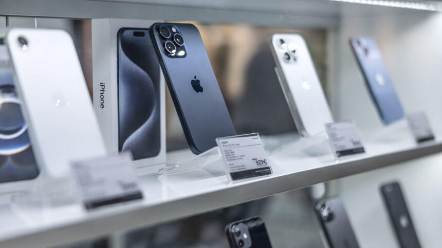 Prague, Czech Republic – April 13, 2025: New Apple iPhones displayed on shelves. Smartphone showcases in an electronics store.