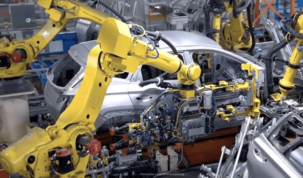 Modern car production is a high-speed choreography where 6-axis articulated robots act as mobile CNC