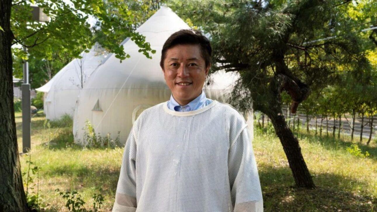 Professor Kitagawa steht vor zwei Fertighäusern auf dem Campus des Nagoya Institute of Technology.
