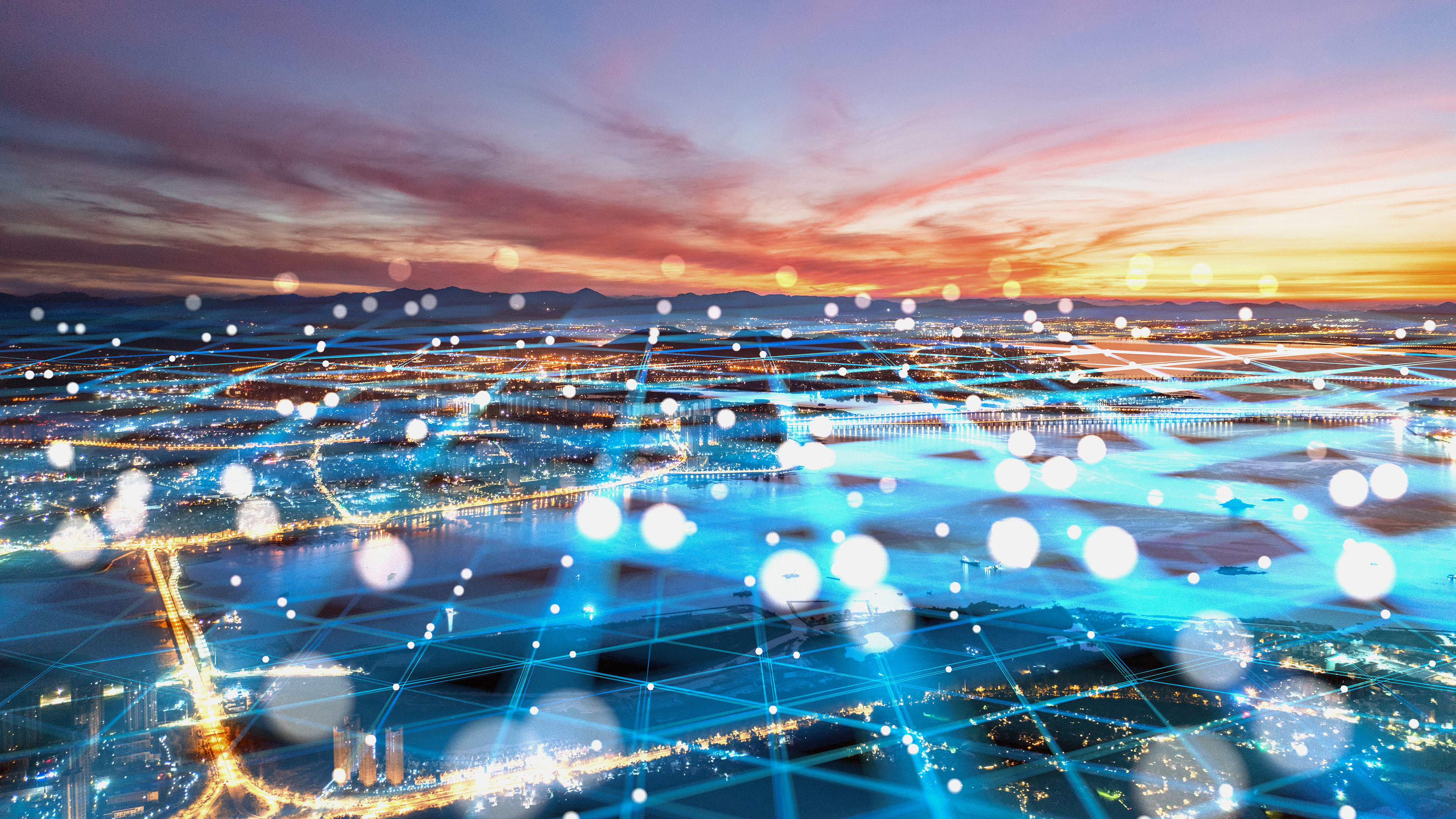 Ein digitales Gitter liegt über den Lichtern der darunterliegenden Stadt