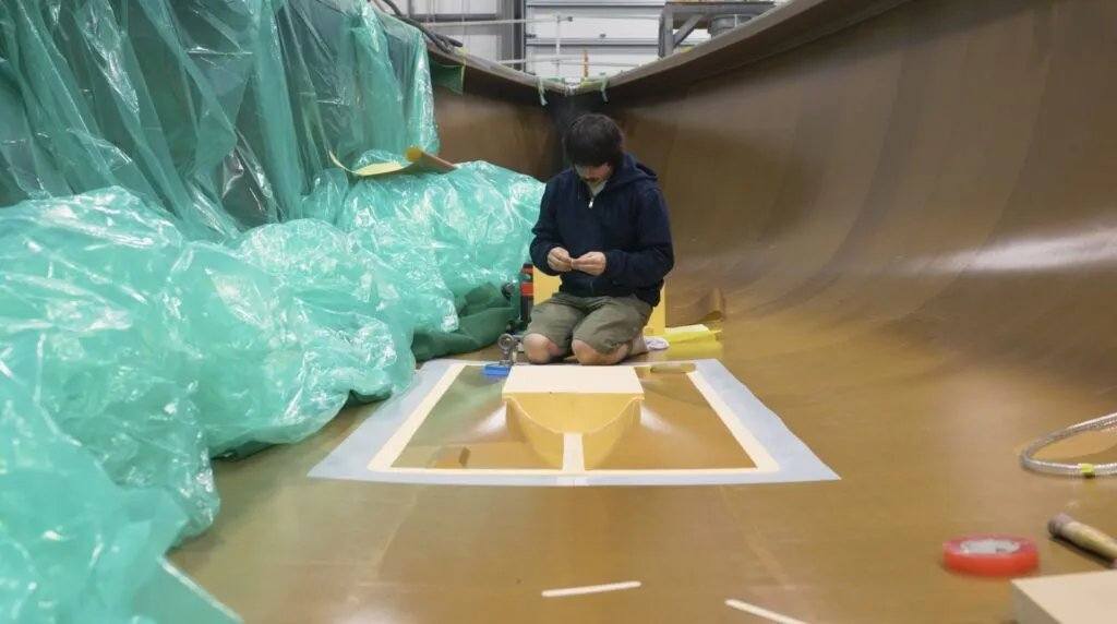Male worker sitting inside the hull, showcasing Moore Brothers joining the 40OF project