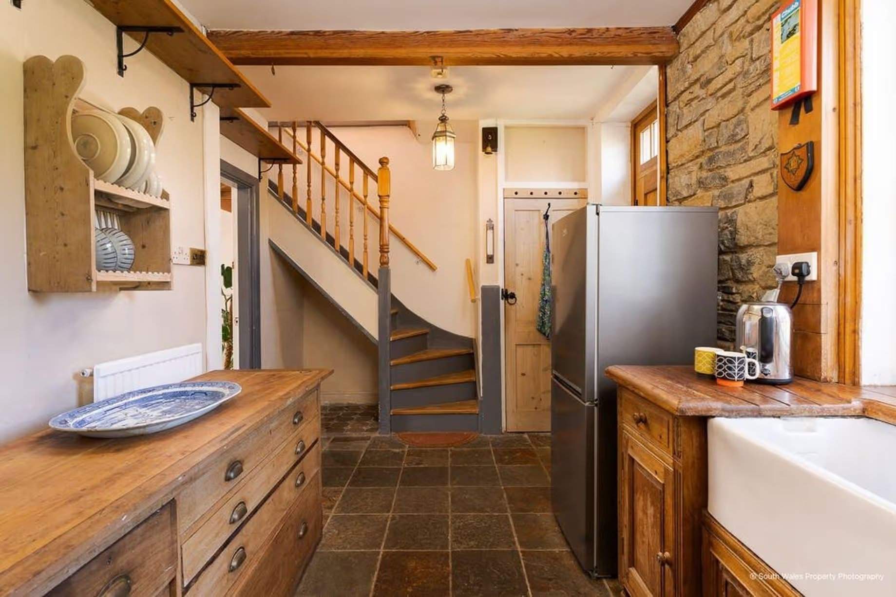 When the listing was granted in 1990, the cottage interior was described as having "moulded cornices, a late Georgian staircase, and some arched alcoves and a large wine cellar", in the kitchen-diner of No. 1 Cottage, exposed stone walls and ceiling beams have also been added, Victorian end-terrace coastguard cottage, Grade II listed, for sale by David Baker (Penarth) with a guide price of over £400,000