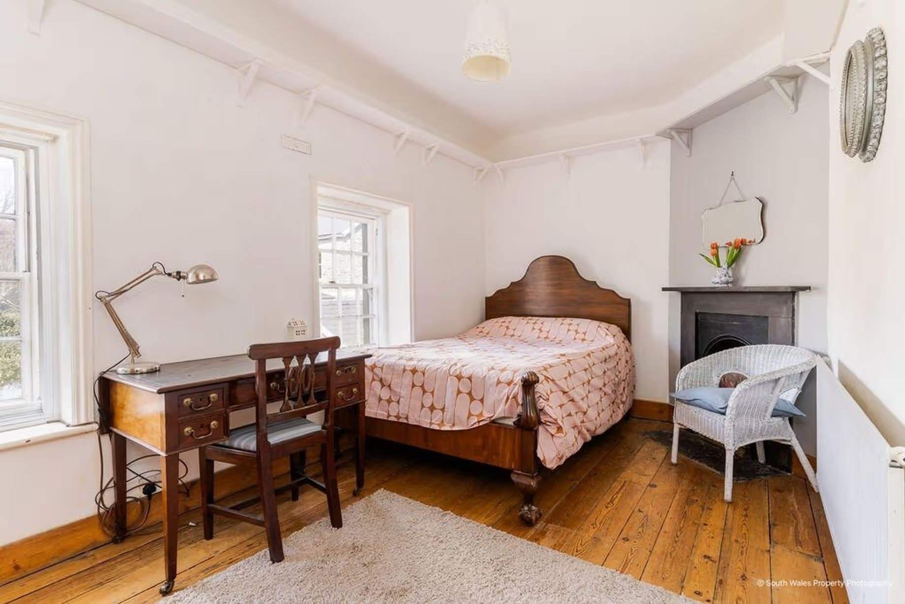 The master bedroom is also full of character – the lovely wooden floor continues, and the fireplace is a delightful surprise, Victorian end-terrace coastguard cottage, Grade II listed, for sale by David Baker (Penarth) with a guide price of over £400,000