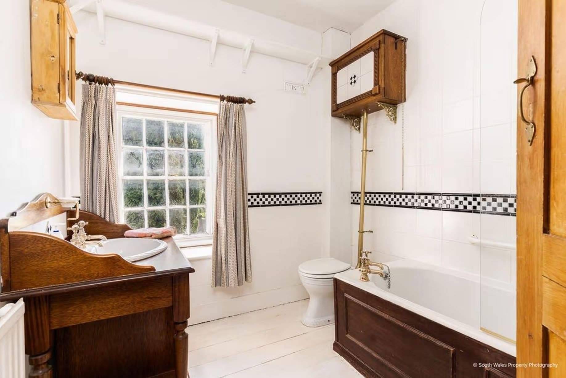 Creating a bathroom in an old house can be a challenge, but this bathroom cheerfully invites you into a space that celebrates the past while offering modern comfort – there is hot water, so no need for a tin bath in front of the master bedroom fireplace, Victorian end-terrace coastguard cottage, Grade II listed, for sale by David Baker (Penarth) with a guide price of over £400,000
