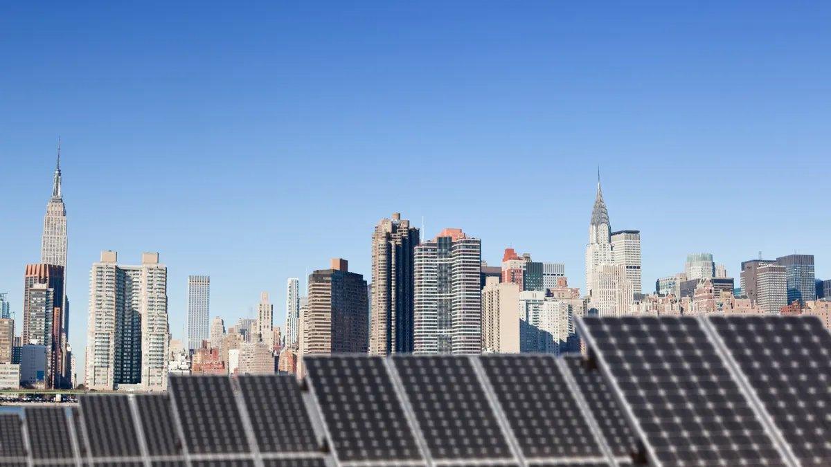 Rooftop solar installation with the Chrysler Building and Empire State Building in Midtown Manhattan in the background.