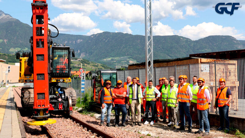 Workers in high-visibility clothing beside railway tracks