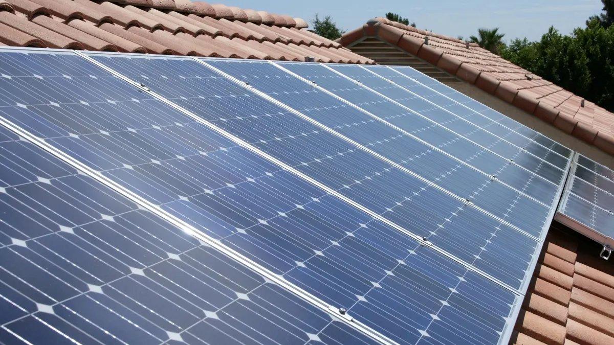 Solar panels sit on a roof.
